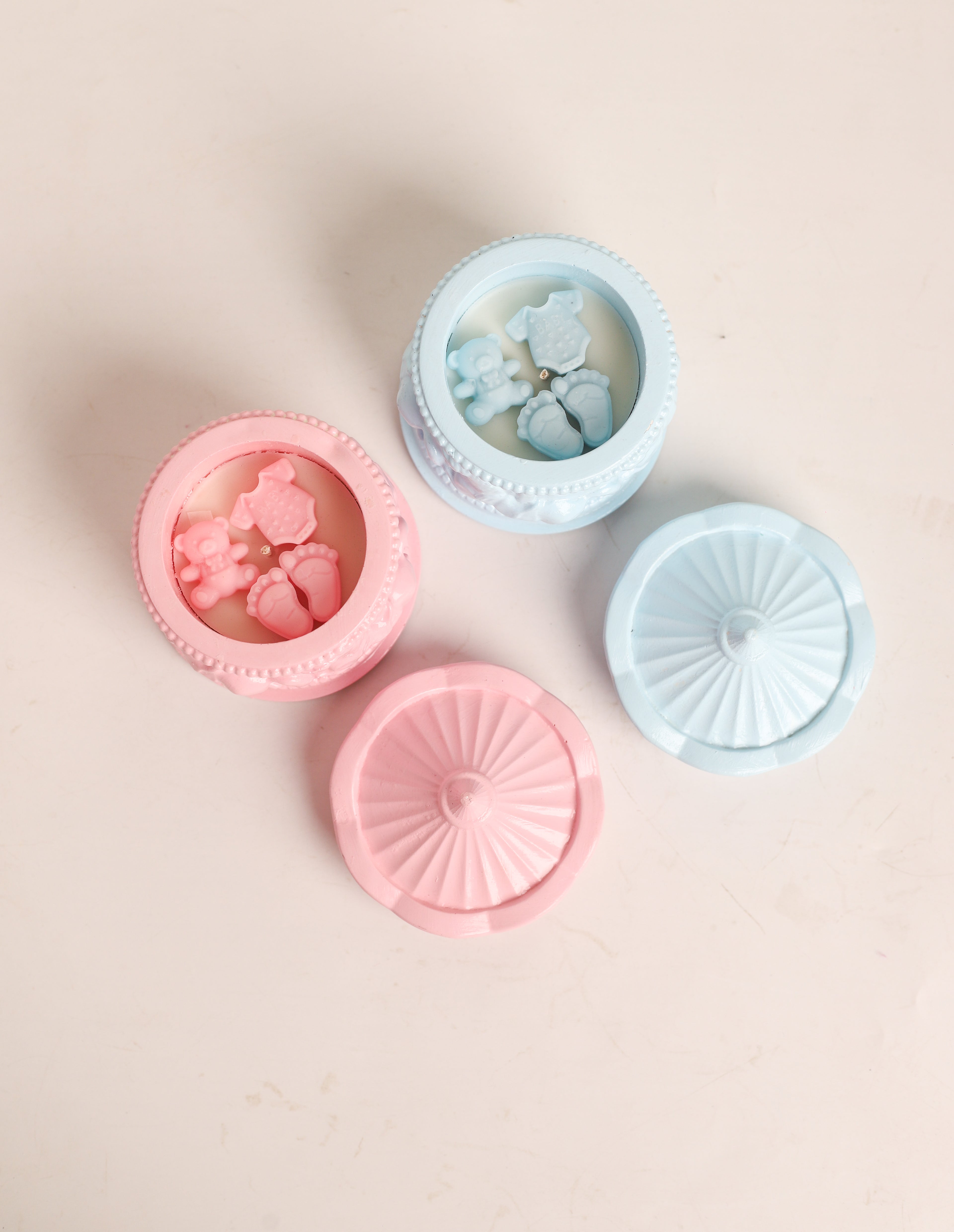 Three silicone mold containers with floral designs on a beige background